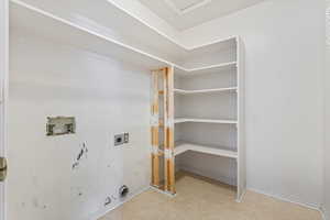 Washroom featuring washer hookup, light flooring, hookup for an electric dryer, and hookup for a gas dryer