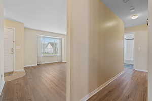 Foyer featuring light wood-type flooring and baseboards