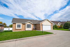 Single story home with concrete driveway, roof with shingles, brick siding, and a garage