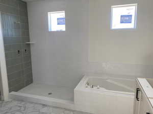 Full bath with vanity, a bath, pet washing area, and tiled shower