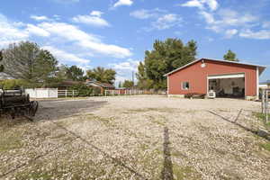 View of property exterior with an outdoor structure, a garage, and an outbuilding