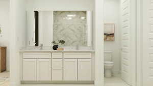 Bathroom featuring double vanity and toilet