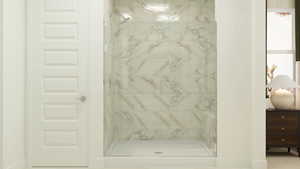 Bathroom with a marble finish shower