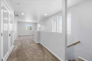Corridor with carpet flooring, an upstairs landing, and recessed lighting