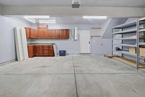 Garage with a garage door opener and a central vacuum unit