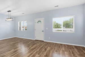 Entrance foyer featuring dark wood finished floors and baseboards