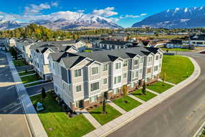 Aerial perspective of suburban area featuring a mountain backdrop