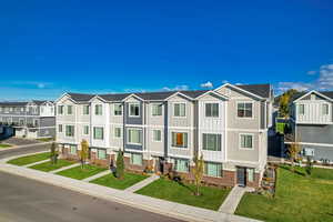 View of front of house featuring a residential view, brick siding, and a front yard