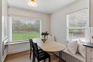 Dining room with light wood-style flooring and baseboards
