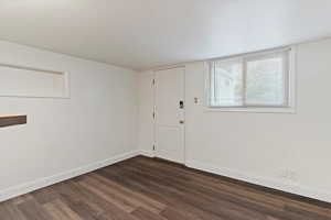 Entryway featuring baseboards and dark wood finished floors