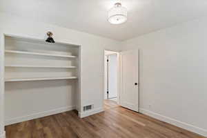 Unfurnished bedroom featuring a closet and light wood-type flooring