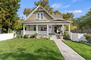 View of front facade featuring covered porch and a shingled roof