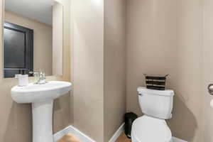 Half bathroom with wood finished floors