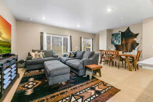 Living area with light wood-style floors and recessed lighting, open great room feel