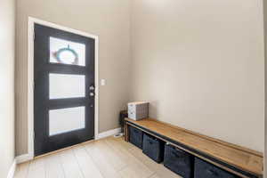 Large foyer entrance featuring light wood-style floors and baseboards