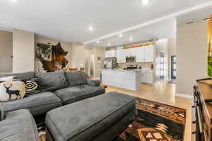 Living area featuring light wood-type flooring and recessed lighting