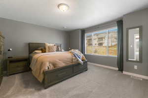 Carpeted bedroom with baseboards and a textured ceiling