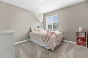 Bedroom with light carpet and baseboards