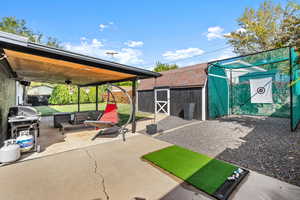 View of patio with ceiling fan, an outbuilding, area for grilling, and outdoor lounge area