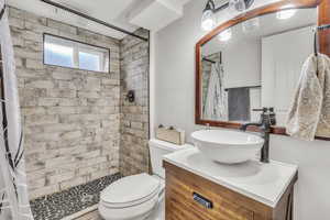 Bathroom with a stall shower and vanity