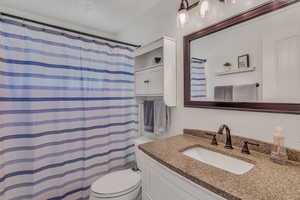 Full bathroom with vanity and a shower with curtain