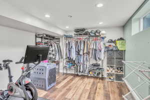 Spacious closet featuring light wood-style flooring