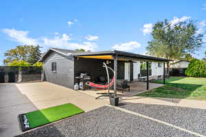 Rear view of property with concrete block siding