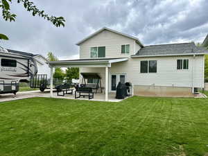 Back of property with a patio, an outdoor hangout area, and roof with shingles