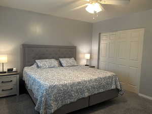 Bedroom with carpet, a closet, and a ceiling fan