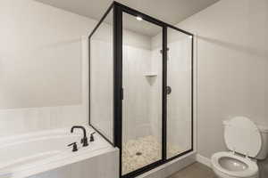 Full bath with tile patterned flooring, a garden tub, and a shower stall