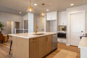 Kitchen with white cabinetry, hanging light fixtures, light wood-type flooring, tasteful backsplash, and recessed lighting