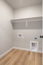 Laundry room featuring wood finished floors, hookup for a washing machine, and hookup for an electric dryer