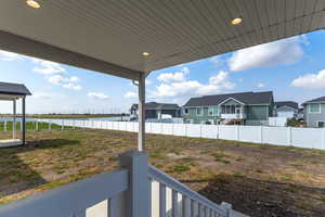 Fenced yard featuring a water view