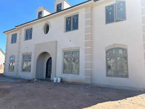 Rear view of property with stucco siding