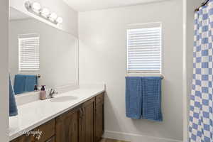 Full bathroom featuring vanity and curtained shower