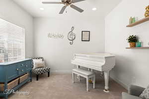 Living area featuring light carpet, recessed lighting, and ceiling fan