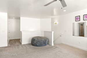 room with light colored carpet, a textured ceiling, and recessed lighting