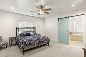 Bedroom with carpet floors, a barn door, recessed lighting, ceiling fan, and multiple windows