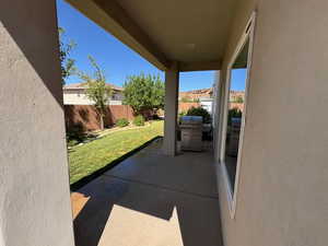 Fenced backyard with a patio area and grilling area