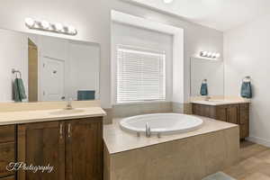 Master bath Full bathroom with two vanities and a bath