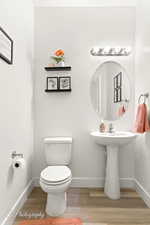 Bathroom featuring baseboards and wood finished floors