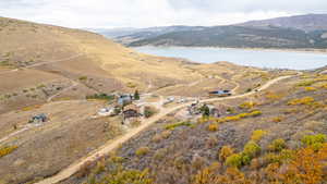 Aerial view of property's location featuring a water and mountain view