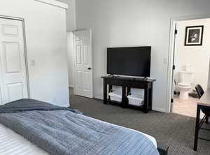 Bedroom with light colored carpet and a closet