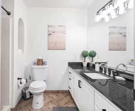 Full bath featuring vanity and light tile patterned floors