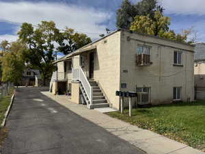 View of property exterior with concrete block siding and a cooling unit
