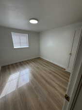 Empty room with light wood finished floors and baseboards