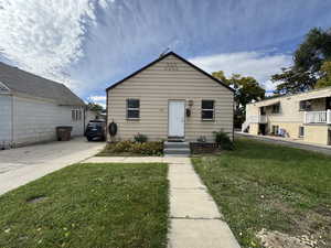 Bungalow-style house with a front lawn