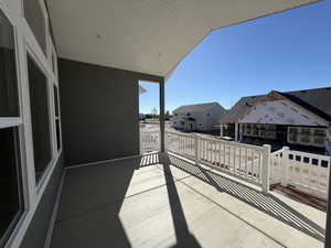 Balcony featuring a residential view and a sunroom