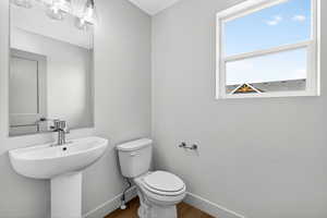 Half bathroom featuring baseboards and wood finished floors