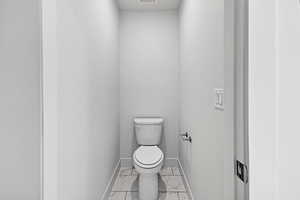 Bathroom featuring marble finish flooring and baseboards